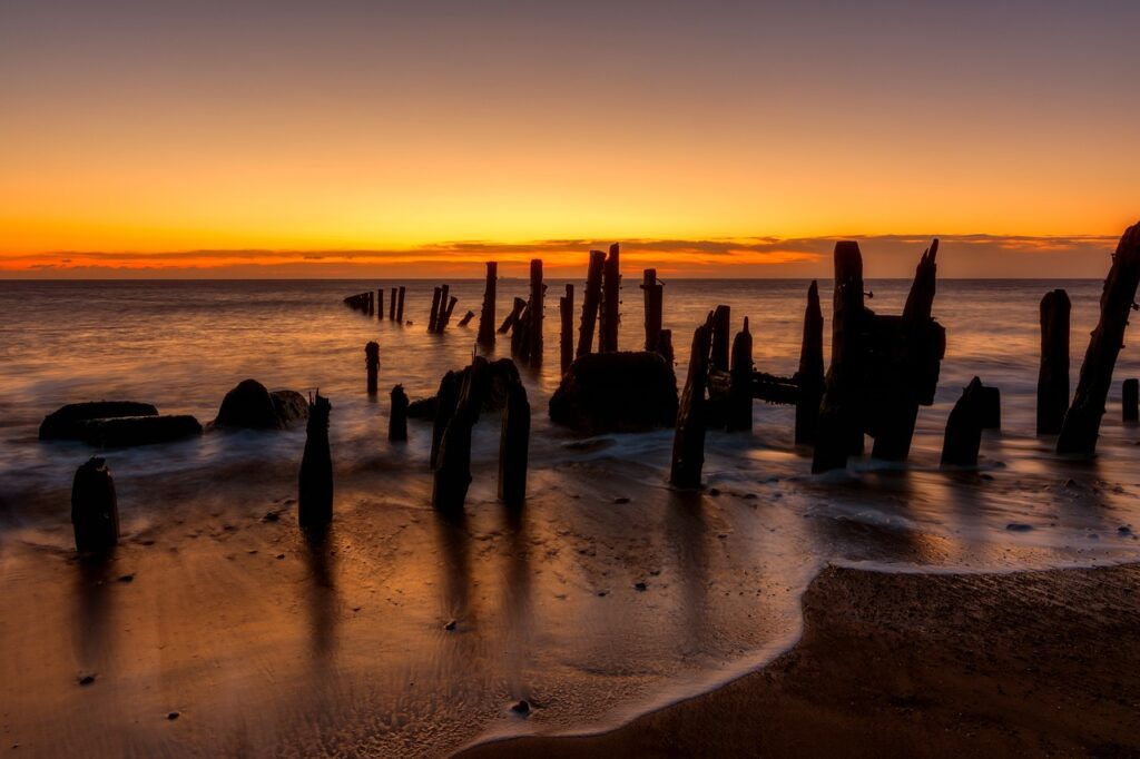 beach, sunset, wooden poles-3010549.jpg